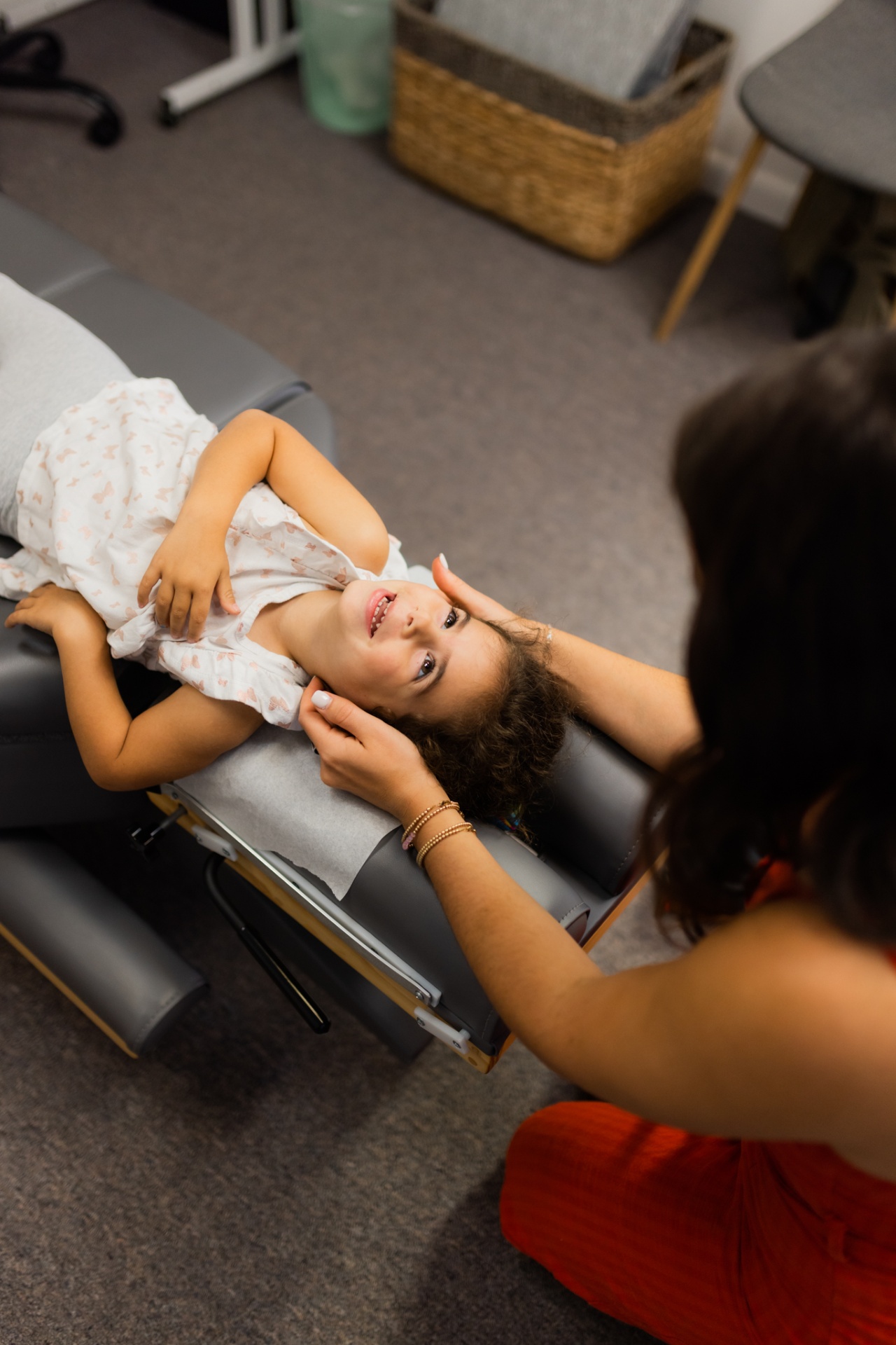 Dr. Alli adjusting an infant on a treatment table