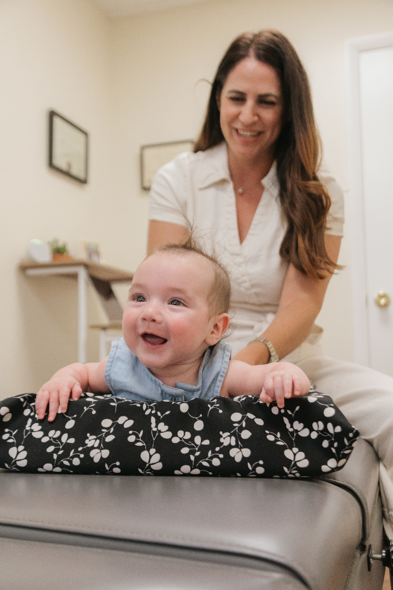 Dr. Alli Parisi providing pediatric chiropractic care to an infant