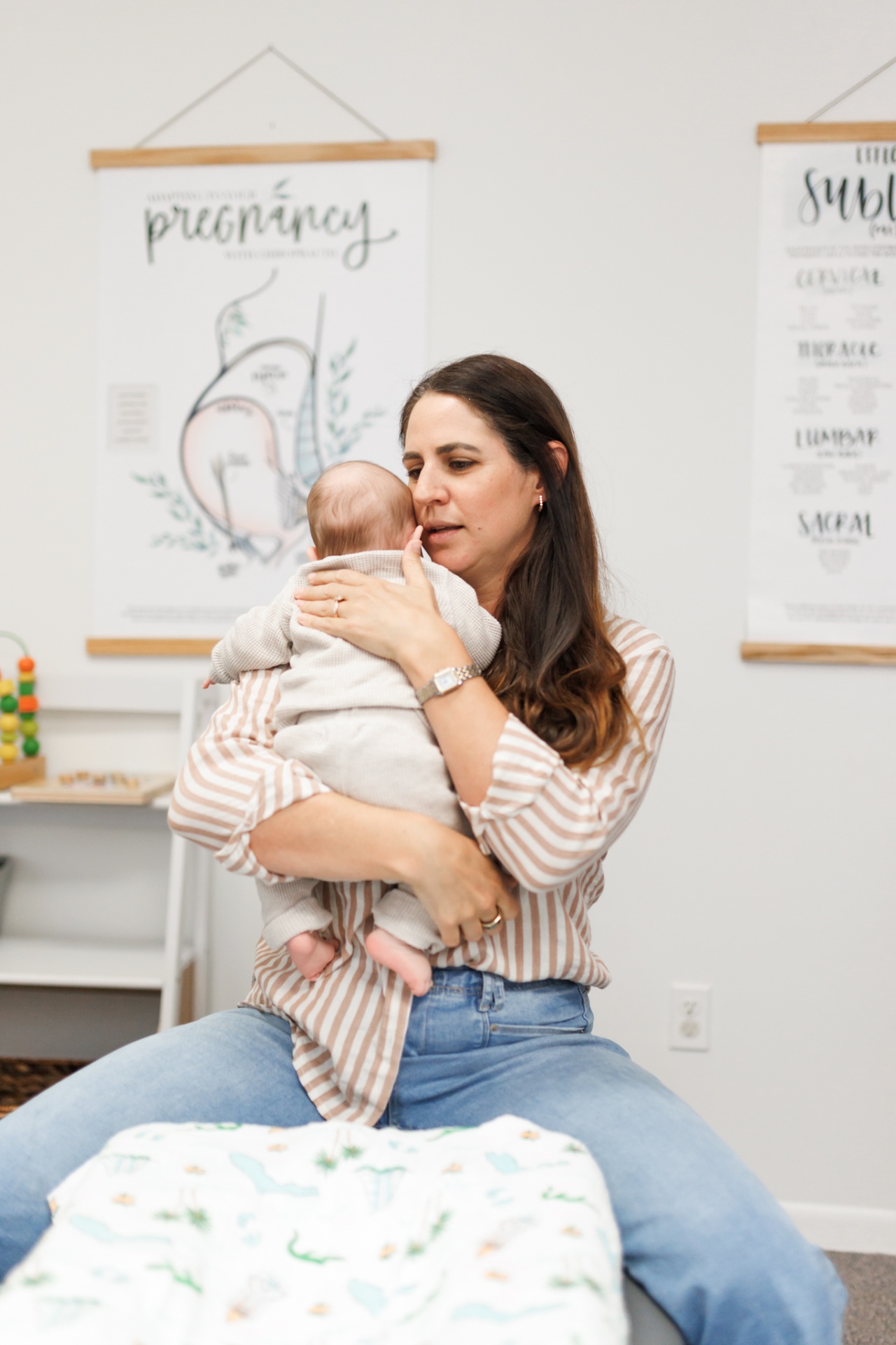 Dr. Alli Parisi holding an infant during a pediatric chiropractic visit